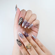 Handmade acrylic nails with shimmer chrome effect and floral accents