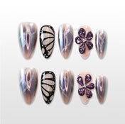 Iridescent press-on nails with butterfly wing and 3D purple flower design