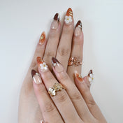Elegant autumn press-on nails with small flowers and gold star design