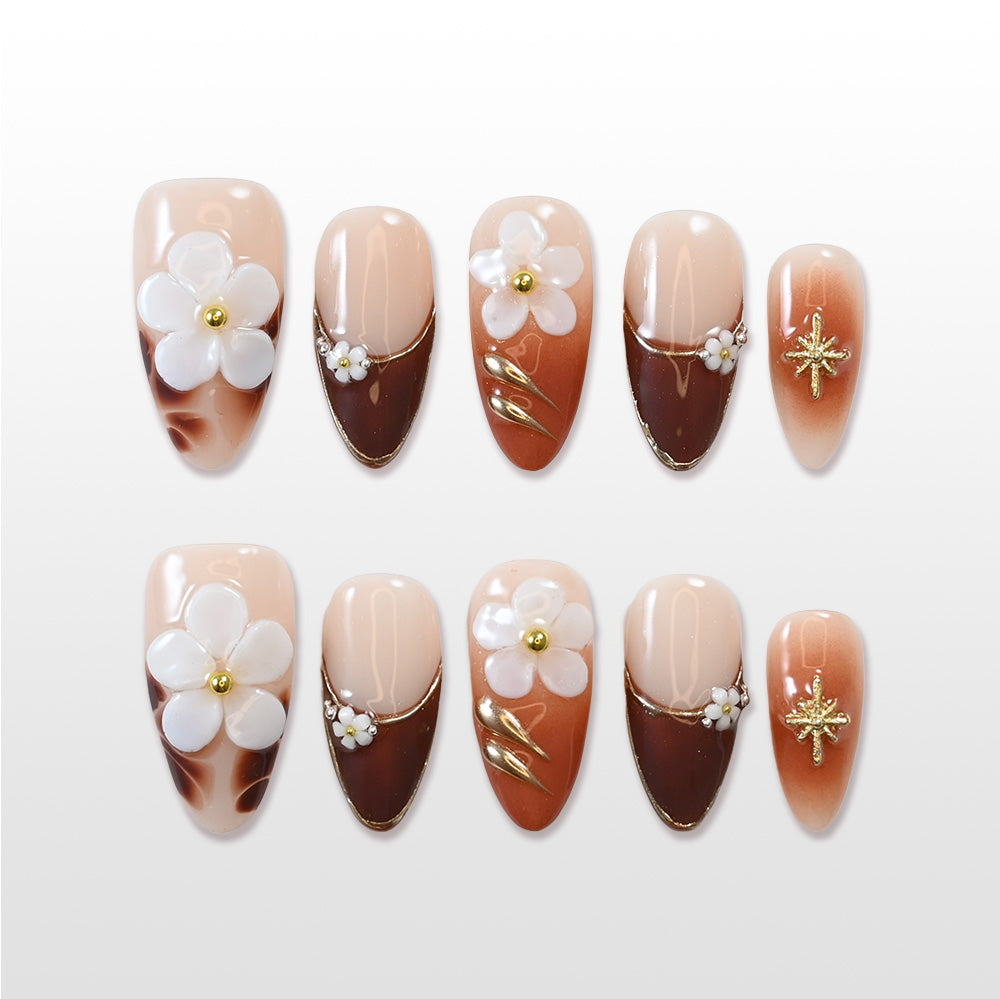 Brown nude press-on nails with 3D white flowers and gold accents