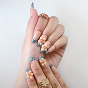 Reusable press-on nails with pink leopard pattern and cream flower gems