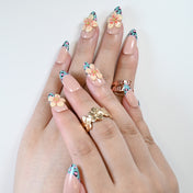 Trendy nail set with colorful leopard tips and 3D blossom embellishment