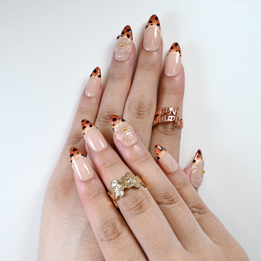 Chic nail set with leopard French tips and clear blossom embellishment