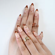 Chic nail set with leopard French tips and clear blossom embellishment