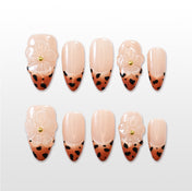 Nude French tip press-on nails with brown leopard print and clear 3D flower design