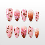 Pink press-on nails with brown floral pattern and 3D flower accent