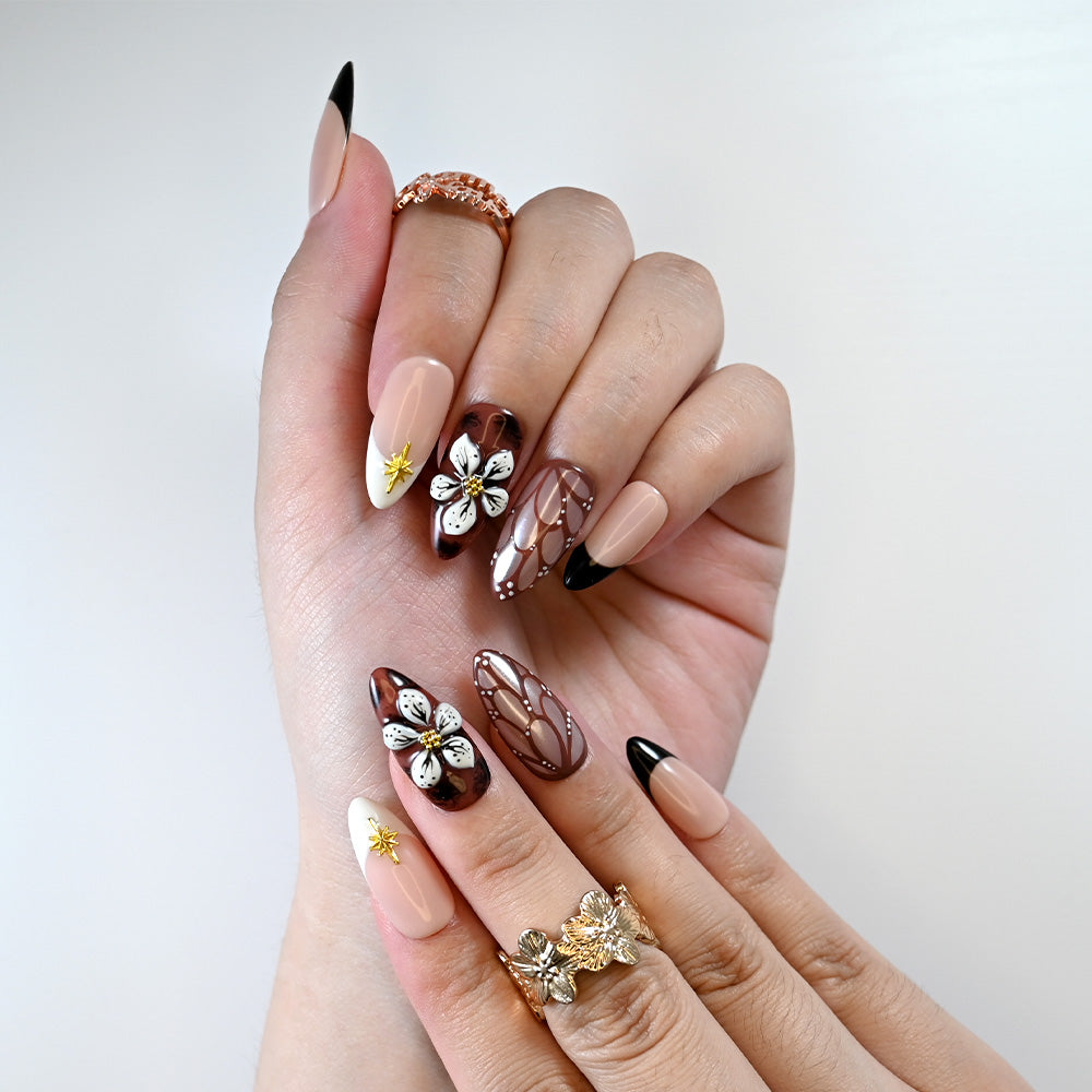 Reusable press-on nails with gold star charm and retro floral details