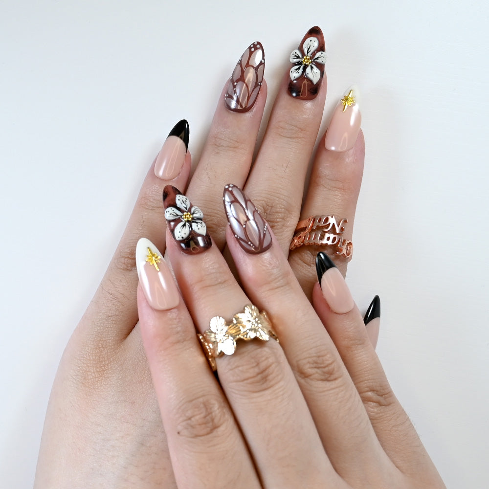 Dark red press-on nails with black French tips and 3D flower accent