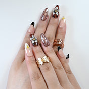 Dark red press-on nails with black French tips and 3D flower accent