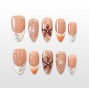 Brown and orange press-on nails with 3D floral art and silver metallic accents
