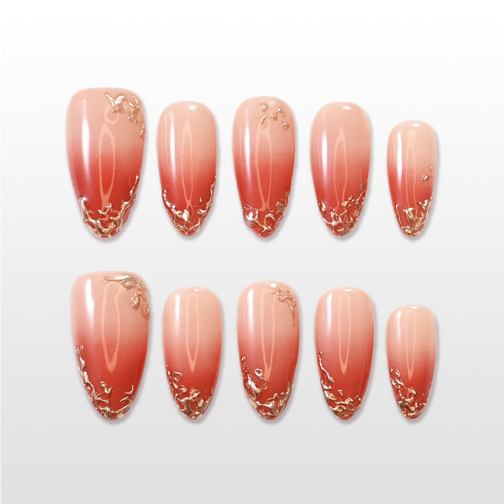 Ombre coral press-on nails with elegant gold foil accents