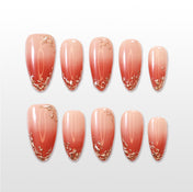 Ombre coral press-on nails with elegant gold foil accents