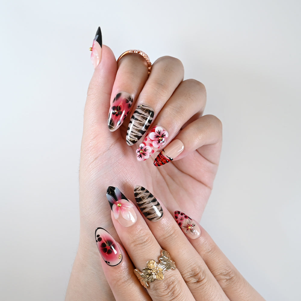 Handmade almond nails with animal print, red gradient, and bold flowers