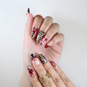 Handmade almond nails with animal print, red gradient, and bold flowers