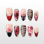 Red and black press-on nails with zebra stripes and 3D floral accents