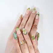 Reusable press-on nails with metallic gold swirl and spring flower details