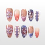 Pink to purple gradient press-on nails with 3D floral and polka dot design