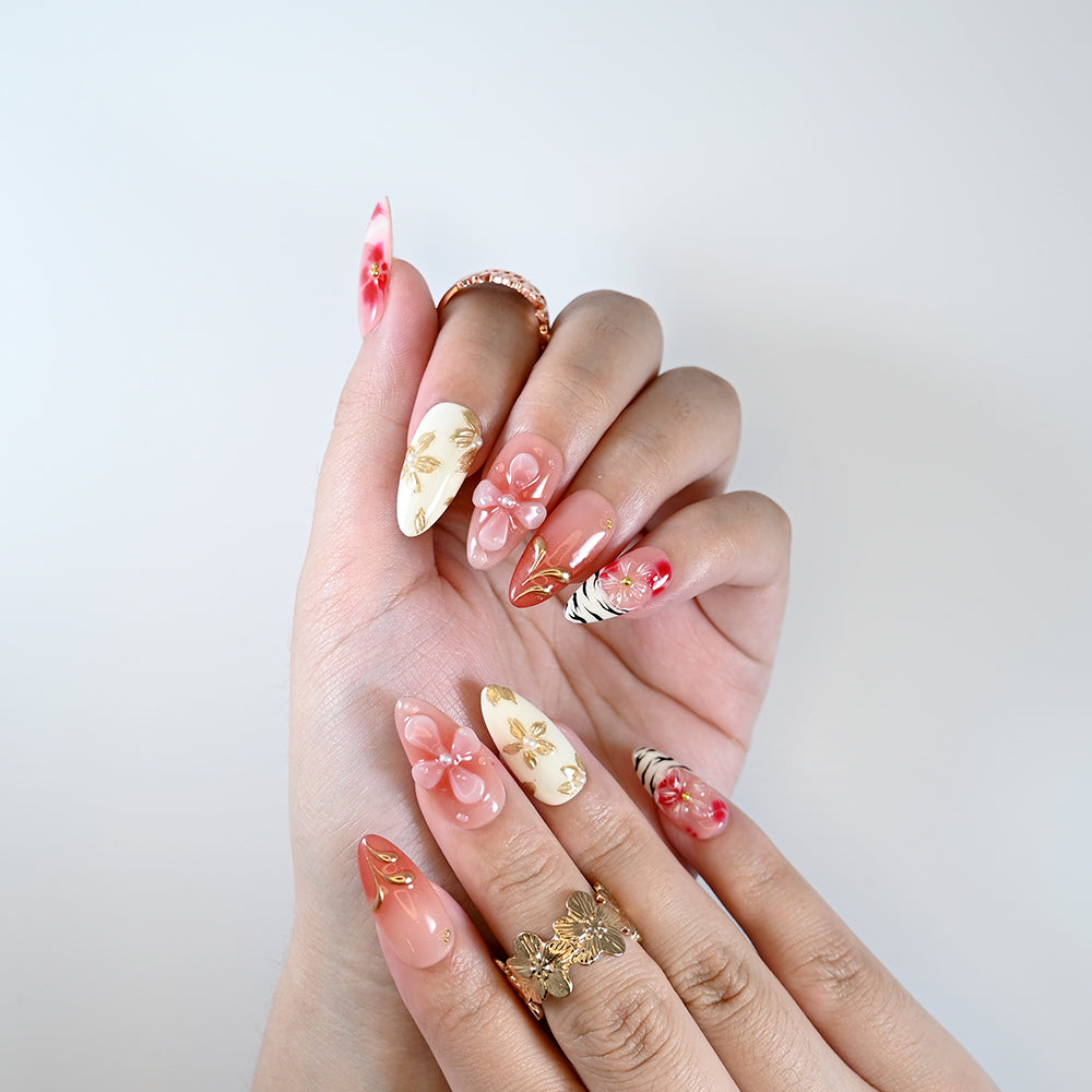 Handmade nude and blush nails with gradient petals and pearl flower art