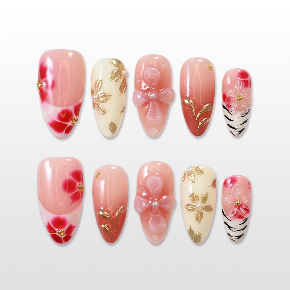 Pink and red floral press-on nails with 3D bow and gold leaf accents