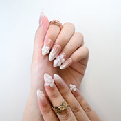 Elegant handmade nails with blush pink shimmer and floral accents