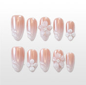 Nude pearl press-on nails with 3D white flower and shell swirl design