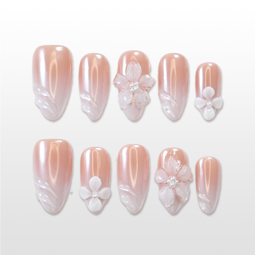Nude pearl press-on nails with 3D white flower and shell swirl design