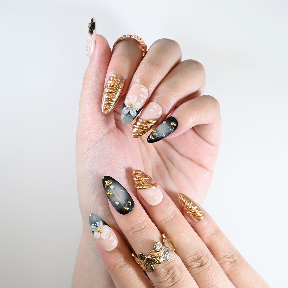 Handmade almond nails with metallic gold sculpted art and flower design
