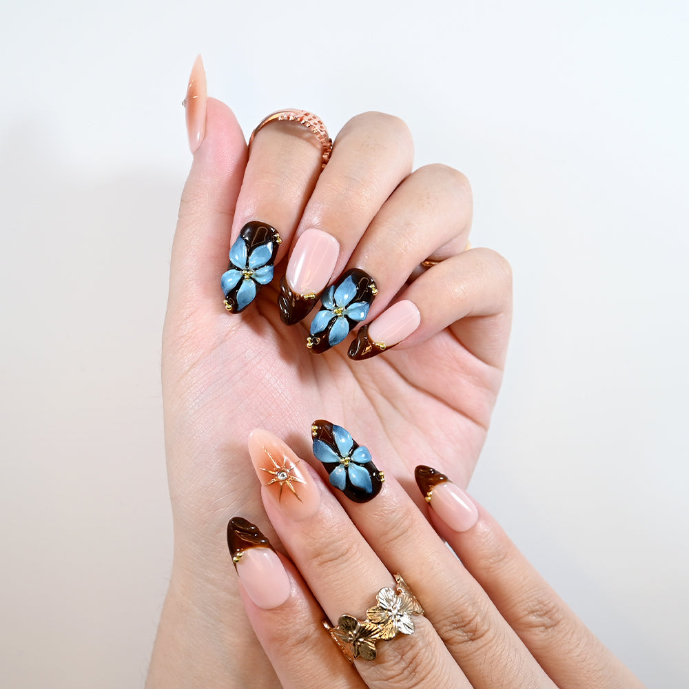 Handmade almond nails with gold star accents and vintage floral design