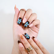 Handmade almond nails with gold star accents and vintage floral design