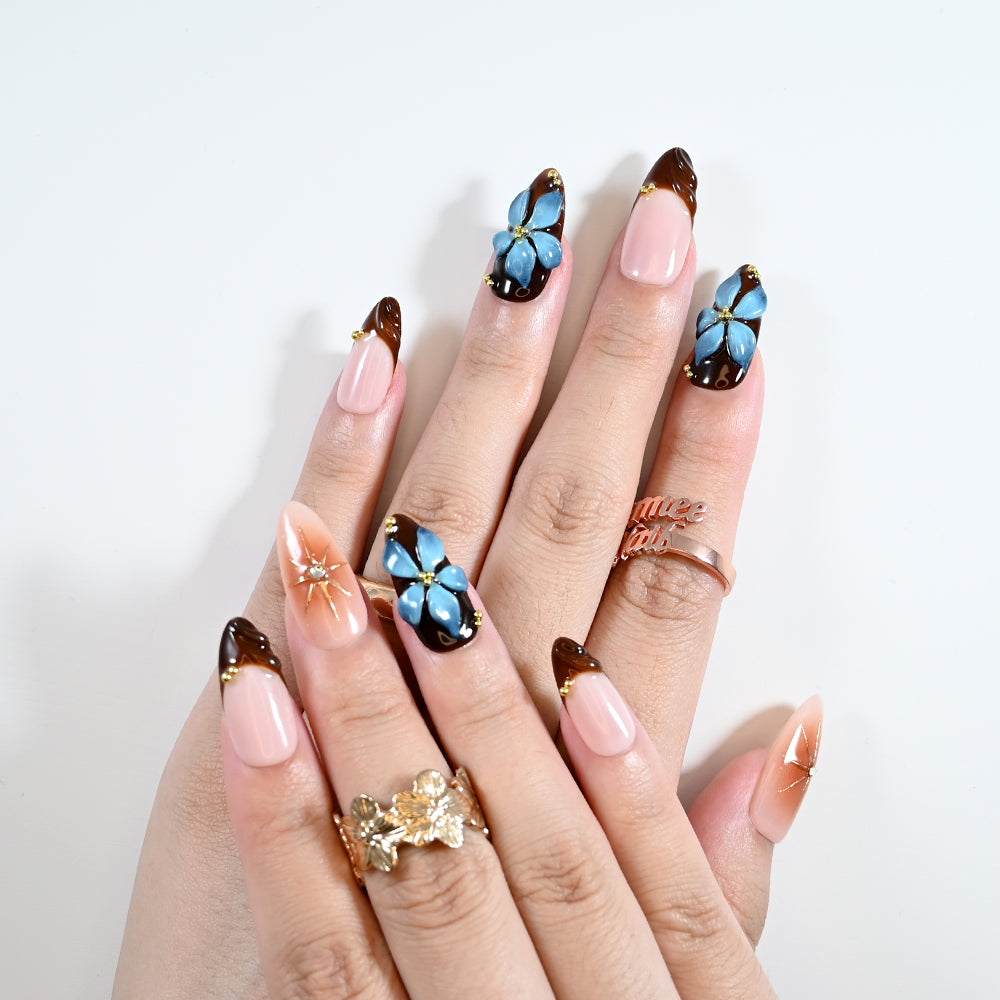 Elegant autumn press-on nails with nude gradient, flowers, and gold details