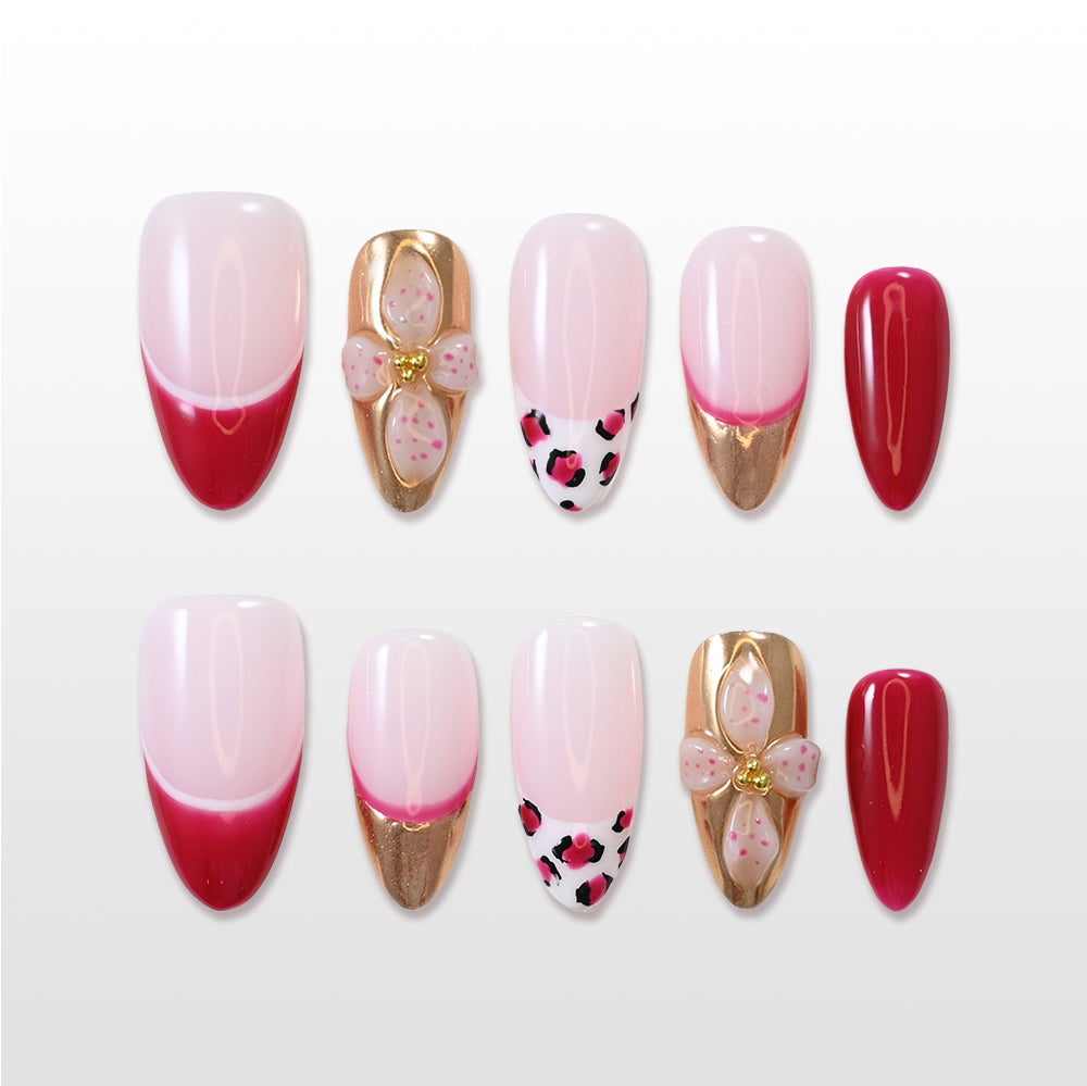 Red French press-on nails with gold tips and 3D flower accent