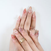 Romantic nude press-on nails with glossy finish and 3D blossom