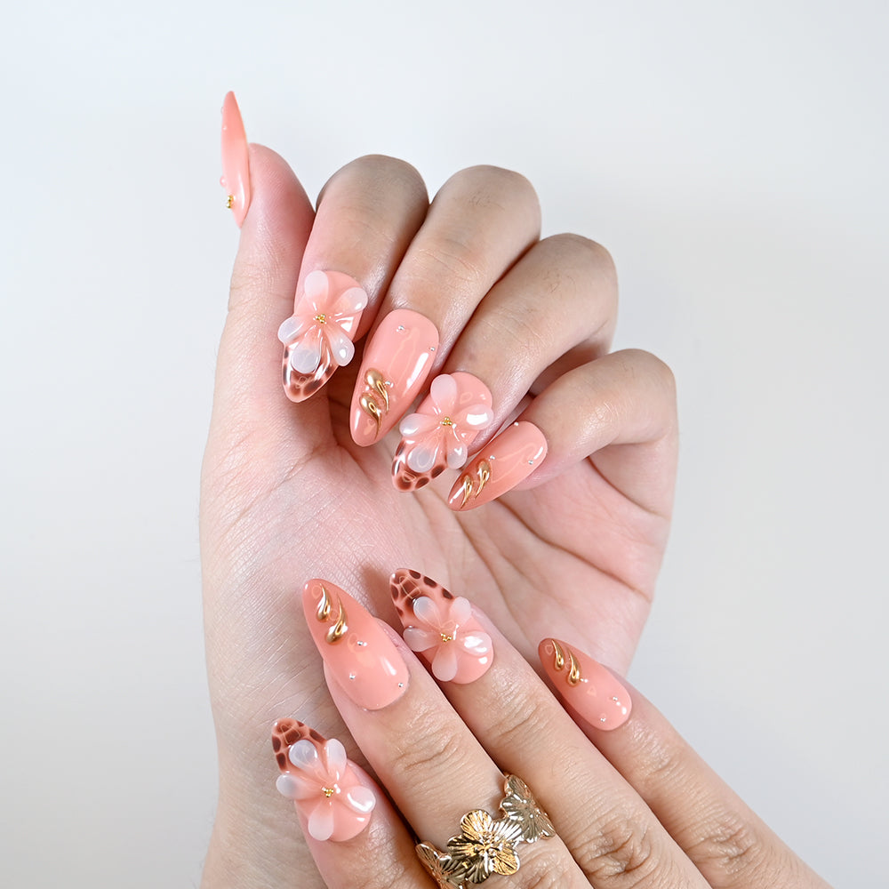 Handmade coral pink nails with animal print detail and blossom art