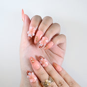 Handmade coral pink nails with animal print detail and blossom art