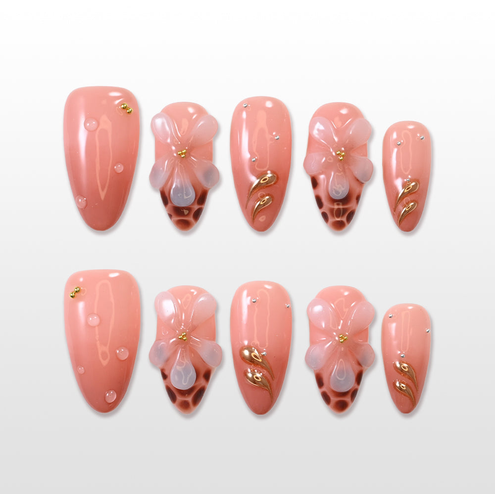 Peach press-on nails with 3D flower and gold leaf accents