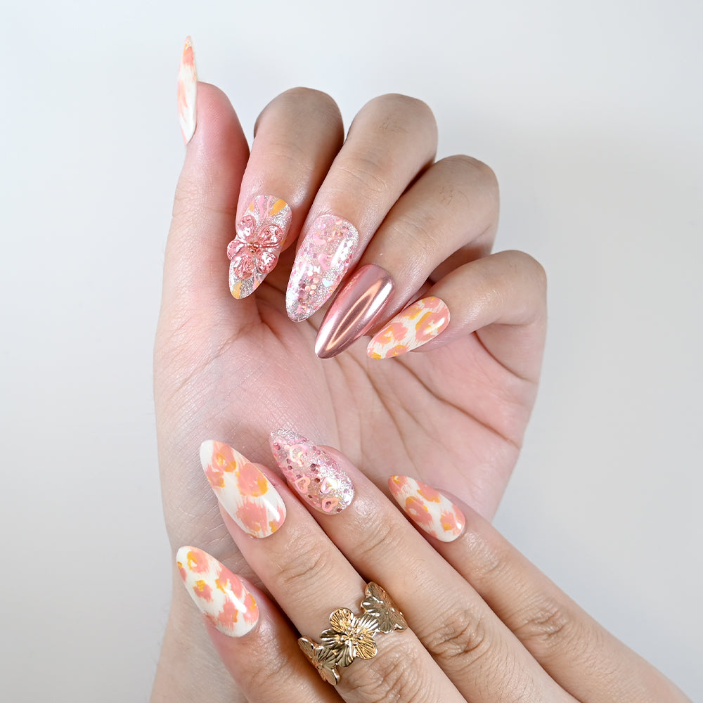 Handmade almond nails with pink floral art and shimmering sequins