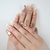 Medium almond reusable press-on nails with yellow flower accents and pearl details