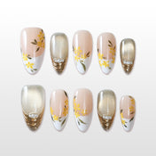 Handmade nude and yellow press on nails with floral and gold glitter design