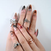 Charmeenail acrylic nails with spooky spider accents and glitter details