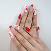 Charmeenail luxury acrylic nails in nude base with red floral hand-painted design