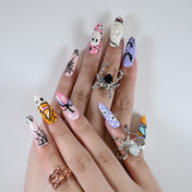 Charmeenail acrylic nails in pink, purple and orange with cartoon bats, pumpkins and webs