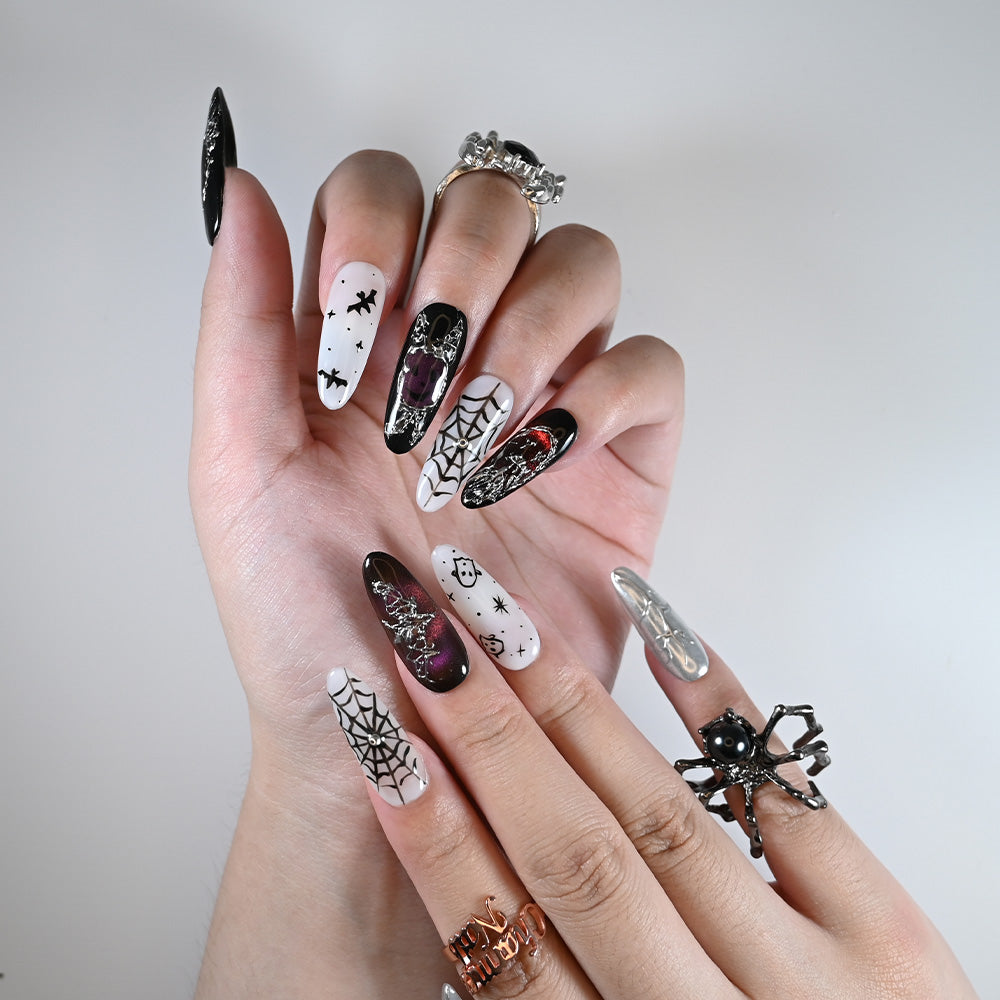 Long almond reusable press-on nails with spooky skulls, webs, and gothic silver accents