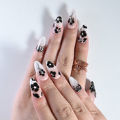 Salon quality nude and black press on nails with 3D cross and floral pattern