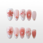 Pink and white French tip press-on nails with 3D cherry blossom floral designs