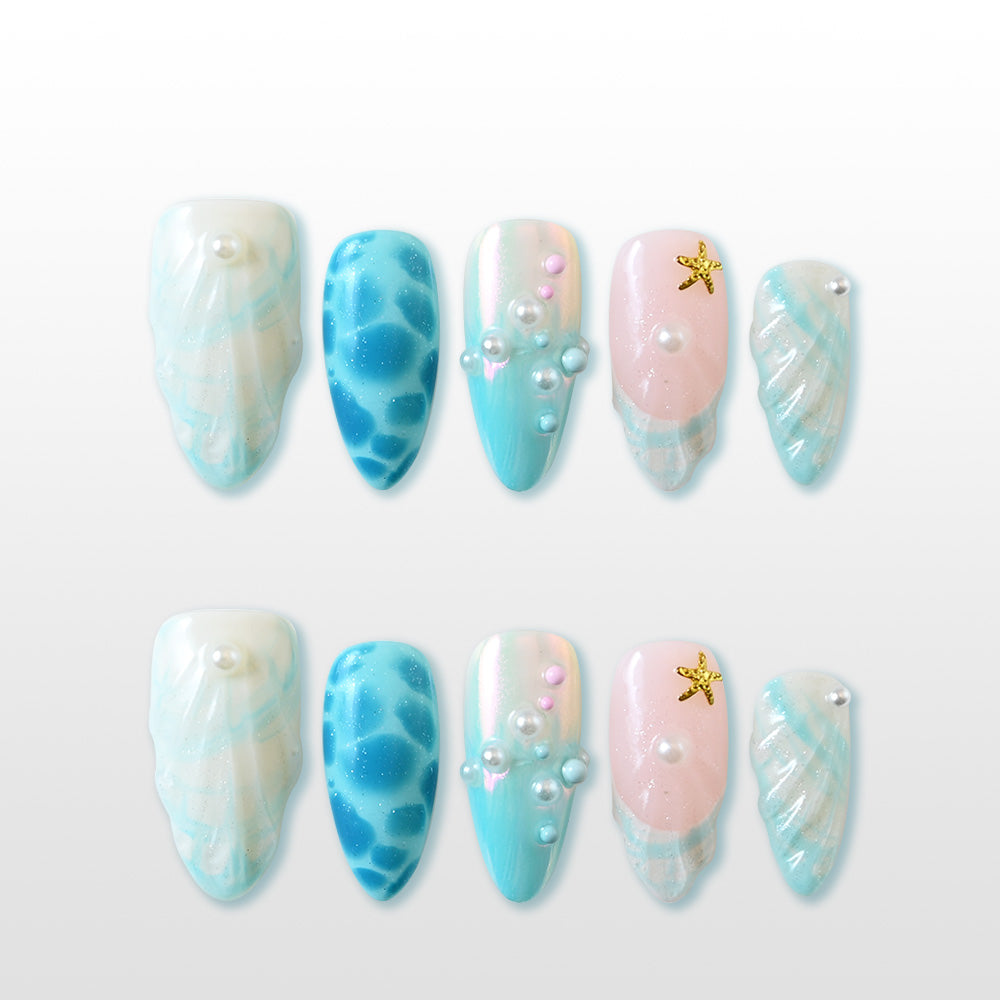 Ocean-inspired press-on nails with seashell texture, pearls, and starfish charm