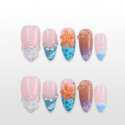 Ocean-themed press-on nails with 3D starfish, pearls, and blue wave designs