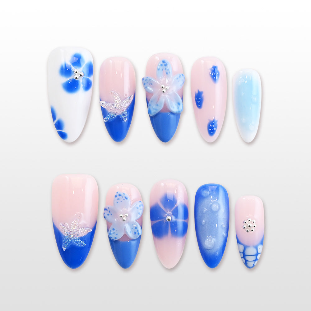Blue and white press-on nails with 3D starfish and floral designs"