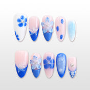 Blue and white press-on nails with 3D starfish and floral designs"