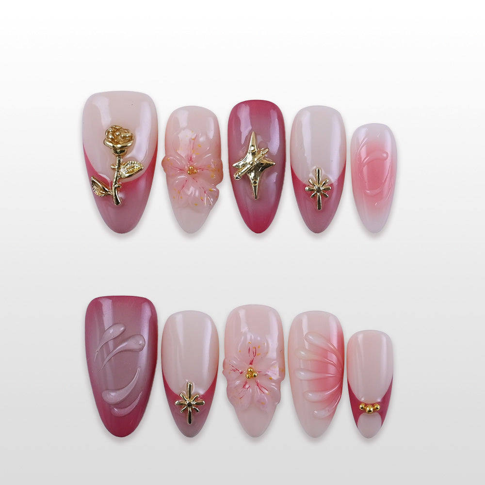 Pink and red ombre press-on nails with gold rose and star charms