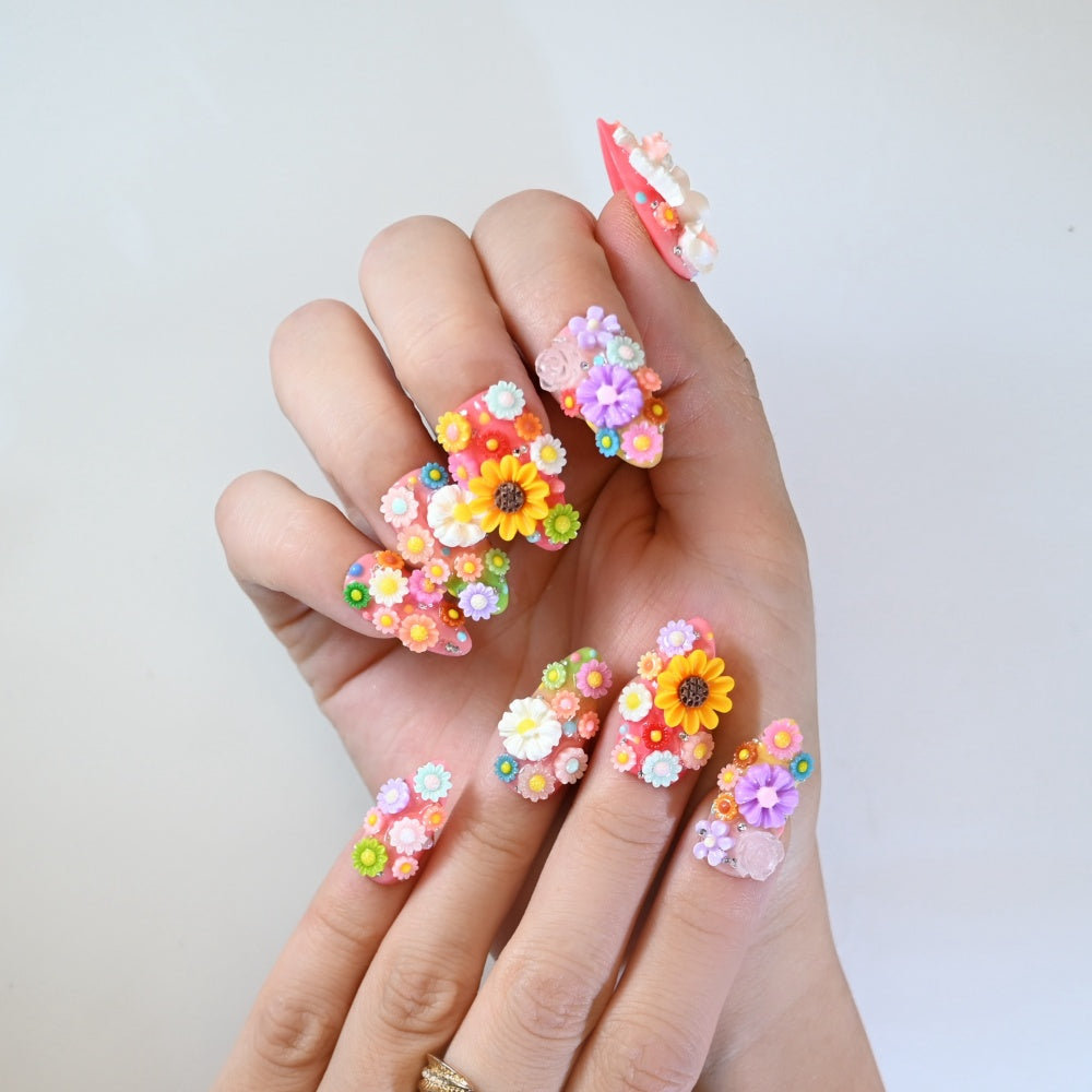 Playful spring press-on nails with oversized sunflowers and pastel floral designs